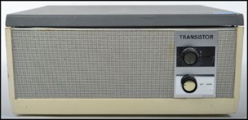 A vintage retro 20th century record player by BSR set in a two tone case with dials to front.