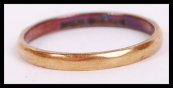 An 18ct hallmarked gold ring of usual simple form bearing Birmingham assay marks. Weighs 1.8g.