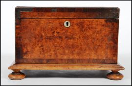 A Victorian 19th century burr walnut tea caddy of square form with hinged lid, sectional interior