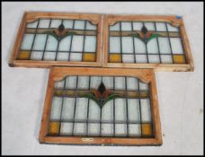 A set of three stained glass windows in framed in