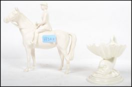 A Beswick white ceramic figurine of a horse and rider together with a white parian glaze Royal