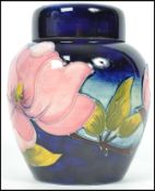A mid 20th century Walter Moorcroft lidded ginger jar painted and tube lined in the Hibiscus pattern