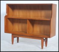 A vintage teak wood mid 20th century open bookcase / shelf with chamfered detailed sides raised on