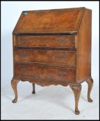 A 20th century walnut bureau, with fall front above concave drawer, two other drawers, raised on