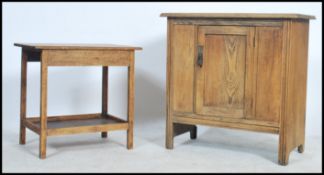 A 1930's stripped oak side cabinet with flared top over cupboard having single central door and