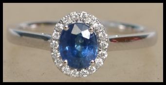 An 18ct white gold, sapphire and diamond cluster r