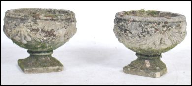 A pair of vintage stoneware garden planters / urns having floral swag decoration raised on square