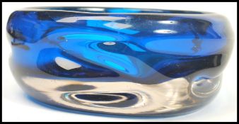 A retro 1970's heavy blue glass dish - ashtray believed to be Whitefriars having rugged design