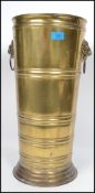 A 19th century Victorian brass stick stand of tall form having a stepped circular base with banded