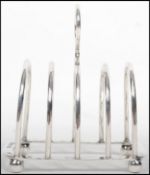 A hallmarked silver toast rack raised on four ball feet bearing hallmarks for Birmingham 1916 by