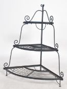 A 20th century ebonised metal waterfall florists display stand of half moon form. Each tier with