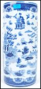 An Oriental ceramic stick stand of tall form having a blue and white decoration depicting scenes