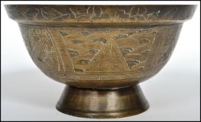 A 20th century Oriental Chinese bronze / brass large censer ding bowl raised on a tapering foot with