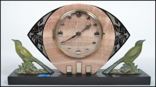 A stunning art deco mantel clock having the fan style back with an inset clock face being made of
