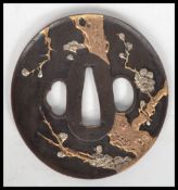 A good bronze Japanese Tsuba being signed and cast in relief with coloured metals ( see