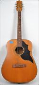 A vintage 20th century Futurama jumbo six string acoustic guitar having a shaped hollow body with