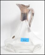 A 20th century silver plated and crystal glass claret jug of hexagonal form having faceted glass