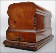 A 19th century Victorian cased sewing machine by Jones model St Pancras having an ebonised body with