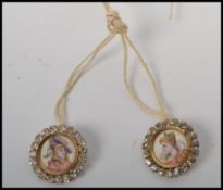 A pair of stunning 19th century continental hand painted portrait buttons, having portraits of a