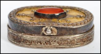 A vintage Kazakhstan silver gilt and Carnelian snuff box from Russian central Asia, fitted with a