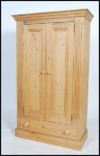 A good quality antique style low pine country cupboard having plinth base with flared top, 2
