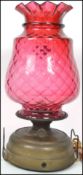 A large 19th century Victorian cranberry glass shade on the form of a pineapple having a flared