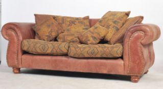 A pair of 20th century large two seat leather Chesterfield style sofa settee's by James Llloyd