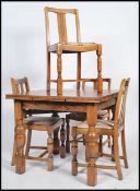 A 1930's Art Deco period oak draw leaf refectory squared dining table being raised on block and