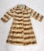 A vintage mid 20th century 3/4 length fur coat by Richard Payne with makers name to floral lined