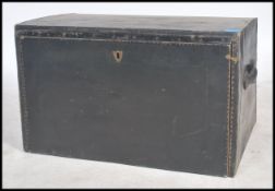 A vintage angled early 20th century car trunk with sloping front and carrying handles to the side,