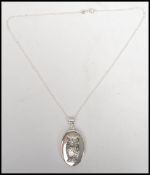 A good silver locked of oval form being hinged and adorned with embossed owl complete with the