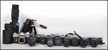 A collection of vintage cameras, lenses and equipment to include Cannon, Minolta, Olympus, Zenit