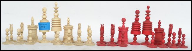 A 19th century Victorian bone chess set of traditional form, one side stained red, the King measures