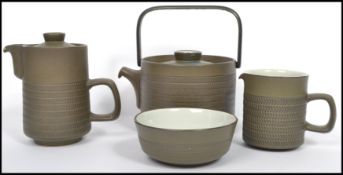 A vintage 1960's stoneware Denby teapot together with the matching creamer and sugar bowl.