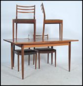 A 1970's G-Plan teak wood extending dining table of rectangular form together with G-Plan ladderback