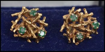 A pair of 9ct gold and emerald stud back earrings in the form of birds nests and each nest having
