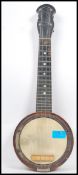 Musical Instruments:  A vintage 20th century four string banjo / Ukulele  of small proportions.