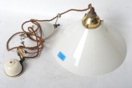 A vintage retro 20th century industrial rise and fall ceramic pendant light having a UFO type