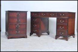 An antique style mahogany and leather twin pedestal office desk together with the matching filing