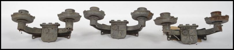 A collection of 3 20th century gothic revival eclesiastical twin light sconces of strap form cast in