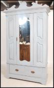 An Edwardian walnut shabby chic painted single wardrobe armoire. The base with shaped legs having