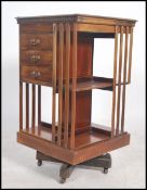 An early 20th century Edwardian mahogany revolving book case having an unusual three drawers to