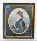 A 19th century oil painting portrait study tondo of a mourning lady dressed in black with flowers