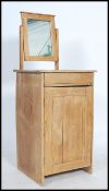 A late 19th early 20th scrubbed pine pot cupboard with a mirror back, single drawer above a single