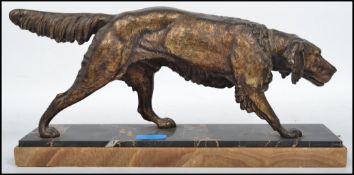 C. Masson: A 20th century bronze figurine of a retriever dog raised on a stepped two tone marble