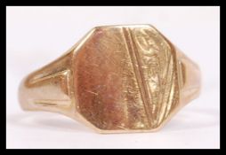 A 9ct hallmarked gold signet ring having an armorial shield shaped front with no inscription and