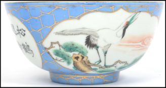 A believed 19th century Oriental ceramic bowl having a blue and gilt ground with white cartouche