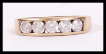 A 9ct gold ladies dress ring inset with 5 cz round