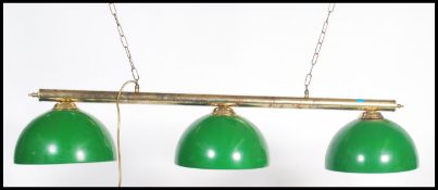 A modern brass ceiling mounted, hanging snooker table down light. Three lights and 3 baize green