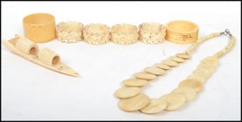 A collection of 19th century ivory wares to include a Oriental boat, bead an counter necklace,